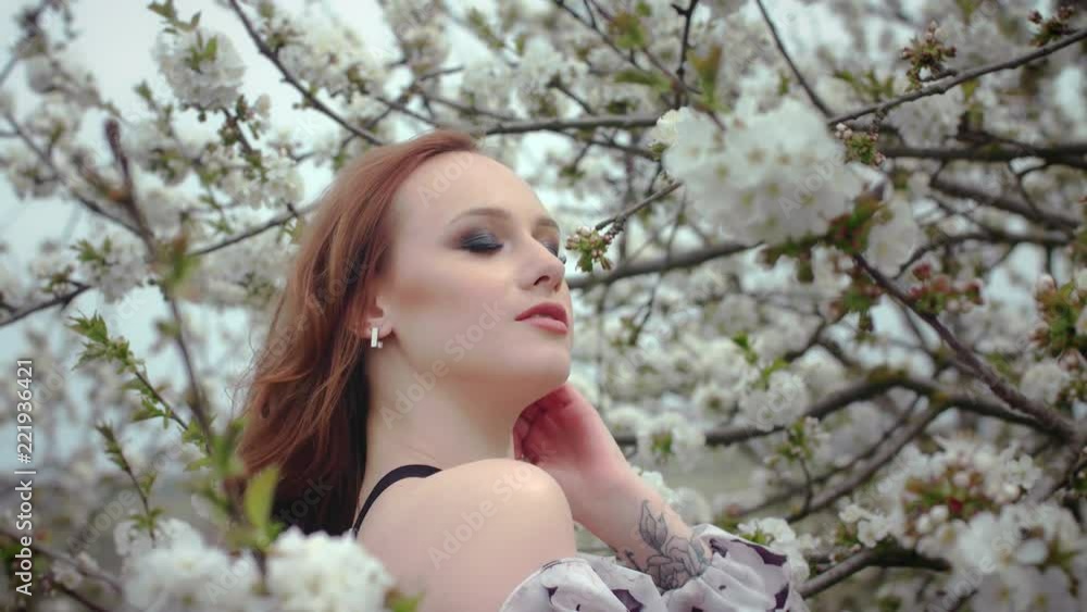 girl posing near blooming trees girl posing near blooming trees