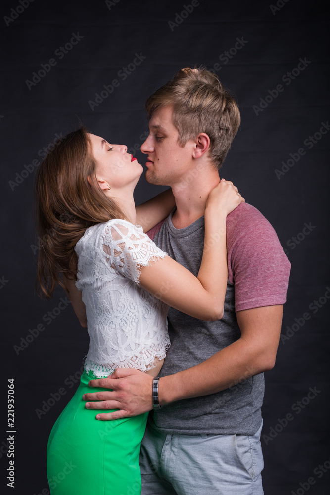 Lovers kissing each other on black background Lovers kissing each other on black background