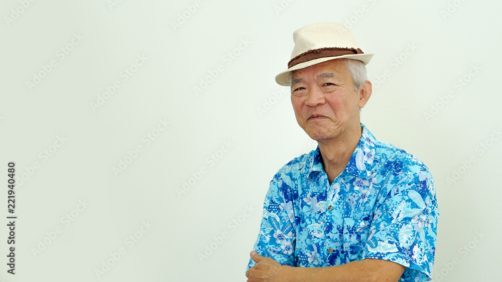 Happy Asian elderly man in Hawaii shirt ready for retirement holiday Happy Asian elderly man in Hawaii shirt ready for retirement holiday