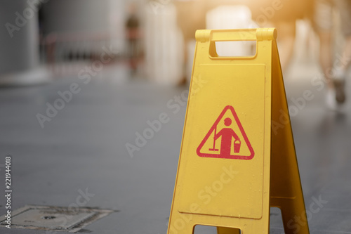 Sign showing warning of caution wet floor whitin airport.