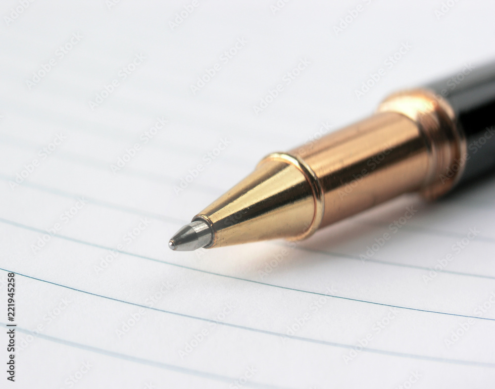 close up.stylish ballpoint pen on notebook sheet close up.stylish ballpoint pen on notebook sheet