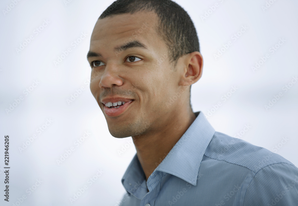 portrait of successful young businessman on background of office portrait of successful young businessman on background of office