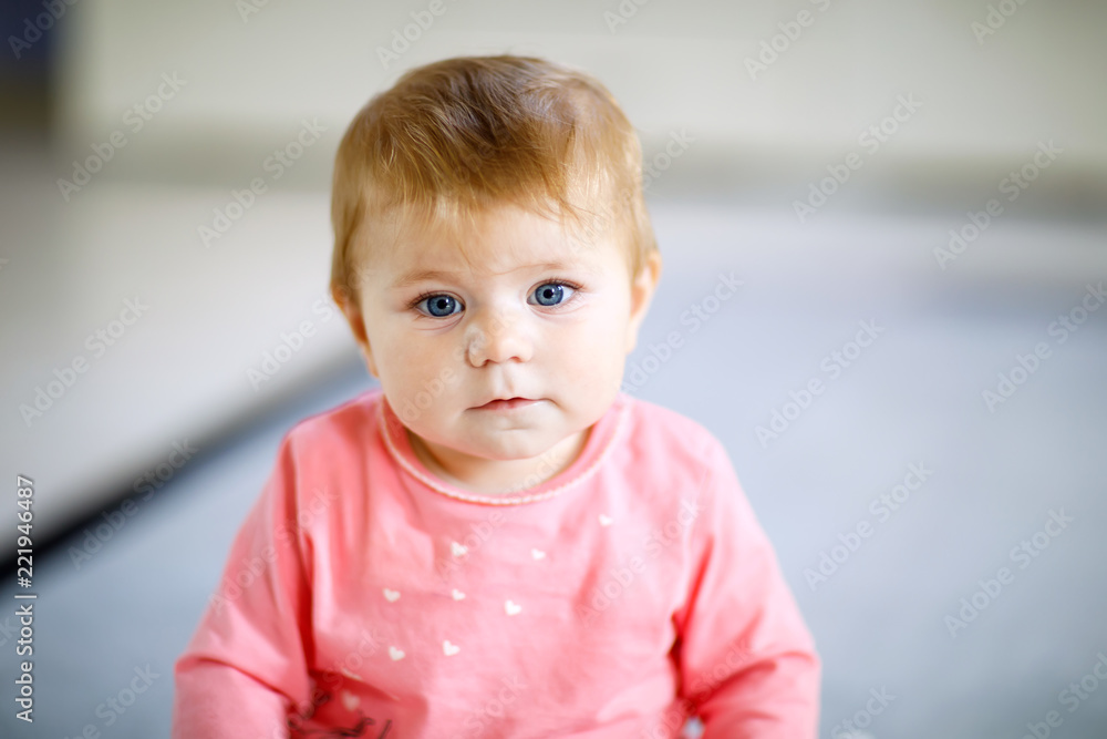 Portrait of cute baby girl at home. Little girl looking at the camera and smiling. Family, new life, childhood, beginning concept Portrait of cute baby girl at home. Little girl looking at the camera and smiling. Family, new life, childhood, beginning concept