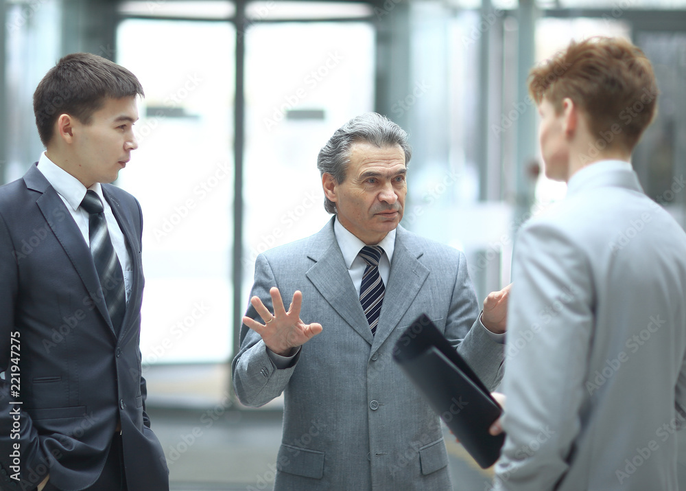strict boss talking with an employee.photo on blurred office background strict boss talking with an employee.photo on blurred office background