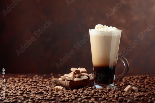 Coffee drink or cocktail with cream and pieces of brown sugar.