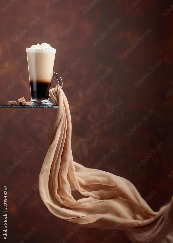 Coffee drink or cocktail with cream and pieces of brown sugar.