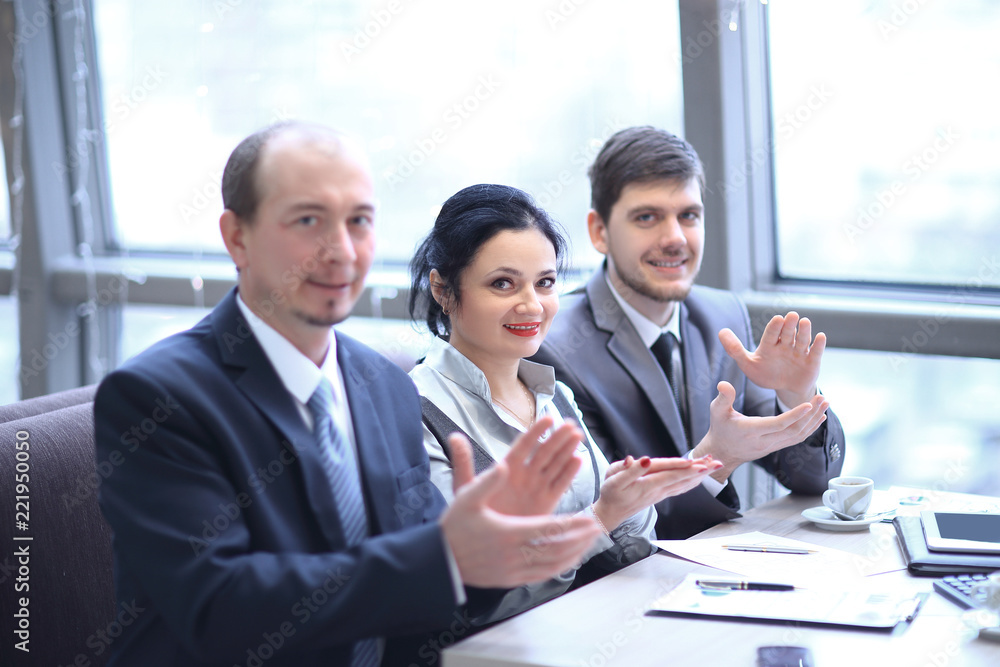 close up.business team applauding the speaker,sitting in the workplace. close up.business team applauding the speaker,sitting in the workplace.