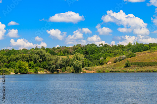 Fototapeta Naklejka Na Ścianę i Meble -  Summer landscape with beautiful lake, green meadows, hills, trees and blue sky