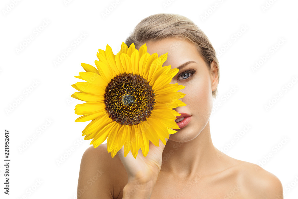 Beautiful young woman with sunflower in her hands