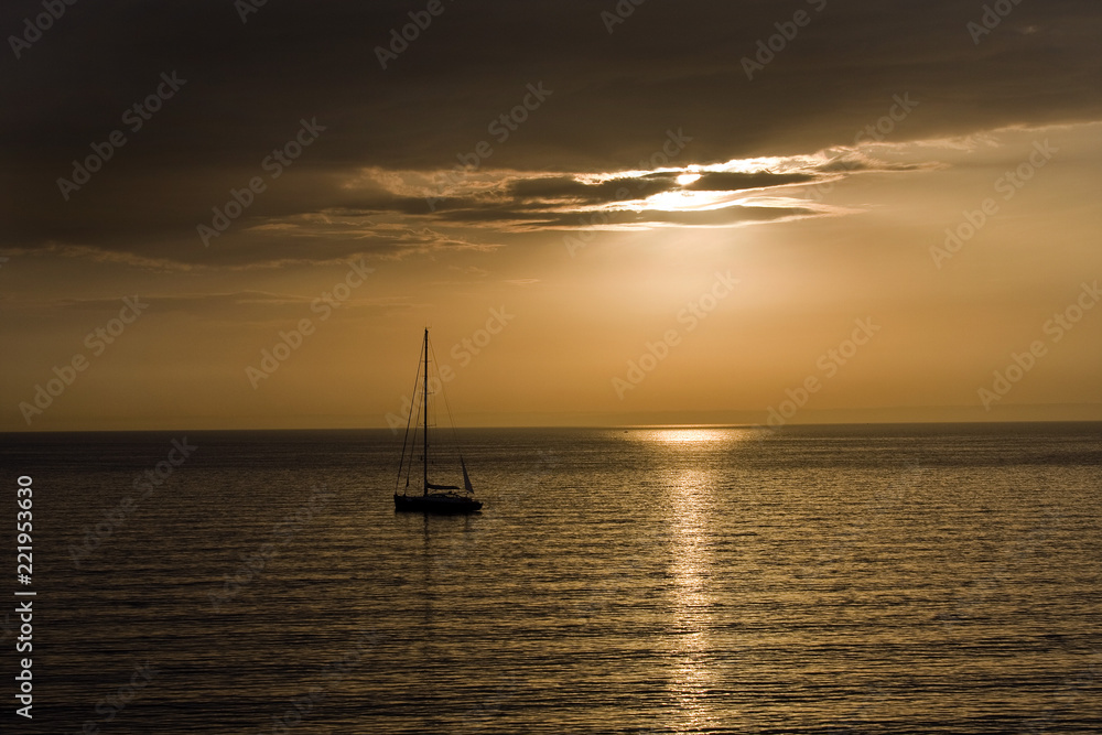 Yacht on the sea against sunrise.