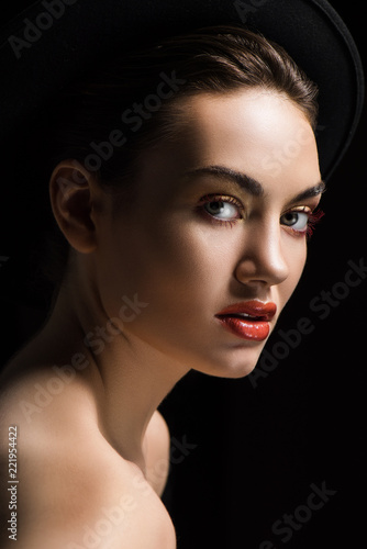beautiful girl posing in elegant felt hat  isolated on black