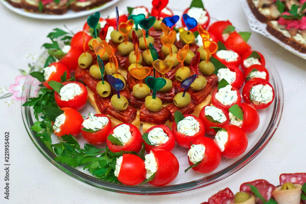 Canape on skewers with cheese, sausage and olives, tomato and on a buffet for a party or wedding, catering