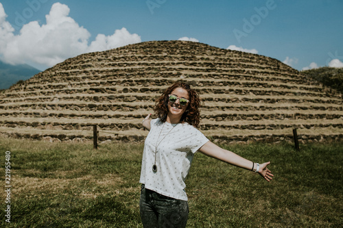 .Young carefree female tourist enjoying the ancient pyramids of Guachimontones near of Guadalajara in Mexico. Maya culture. Lifestyle portrait. photo