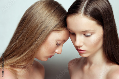 studio portrait of two young beautiful women. Beauty Woman face Portrait. Beautiful Spa model Girl with Perfect Fresh Clean Skin. Youth and Skin Care Concept.