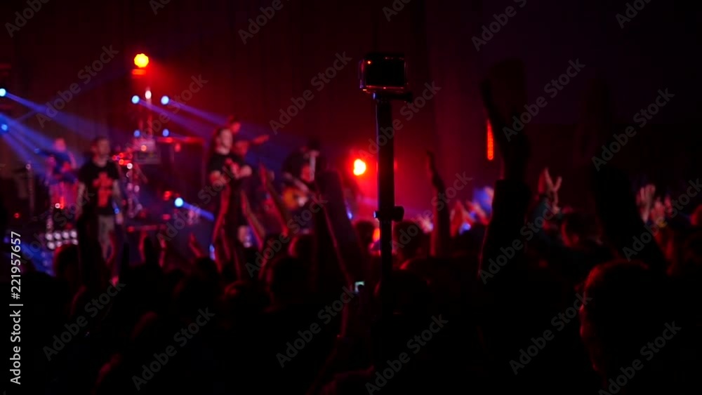 Crowd fan spectators silhouettes raise clap hands at concert light lumiere