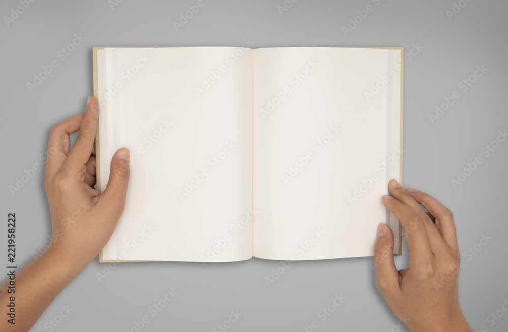 Obraz premium Top view- two hands hold a empty book spread