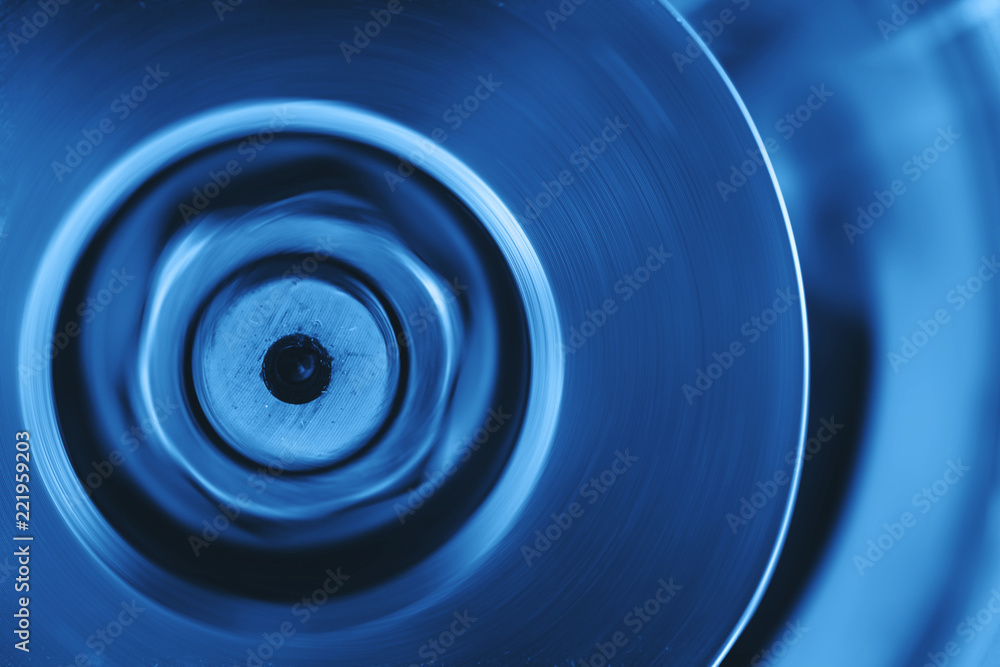 Part of rotating mechanism close-up. Brutal auto part in cobalt tone. Monochrome blue background of metal device. Part of rotating mechanism close-up. Brutal auto part in cobalt tone. Monochrome blue background of metal device.