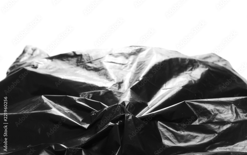 Crumpled, black plastic bag, isolated on white background, design elements, side view Crumpled, black plastic bag, isolated on white background, design elements, side view