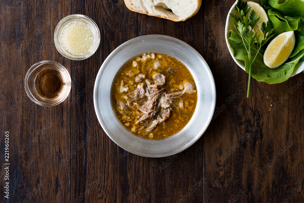 Turkish Soup Beyran with Lamb Meat, Rice, Chopped Garlic and Vinegar Sauce Served with Salad. Turkish Soup Beyran with Lamb Meat, Rice, Chopped Garlic and Vinegar Sauce Served with Salad.