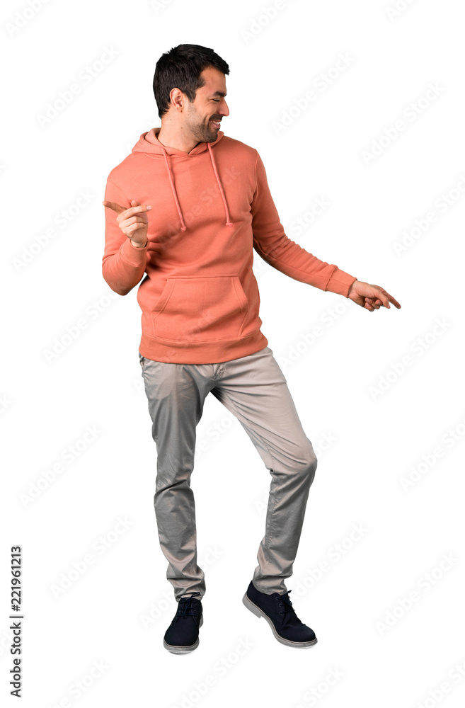 Full body of Man in a pink sweatshirt enjoy dancing while listening to music at a party on isolated white background. Ideal for use in architectural designs Full body of Man in a pink sweatshirt enjoy dancing while listening to music at a party on isolated white background. Ideal for use in architectural designs