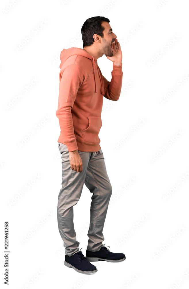 Full body of Man in a pink sweatshirt shouting with mouth wide open and announcing something on isolated white background Full body of Man in a pink sweatshirt shouting with mouth wide open and announcing something on isolated white background