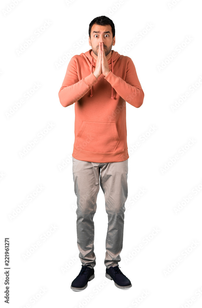 Full body of Man in a pink sweatshirt pleading for something on isolated white background Full body of Man in a pink sweatshirt pleading for something on isolated white background