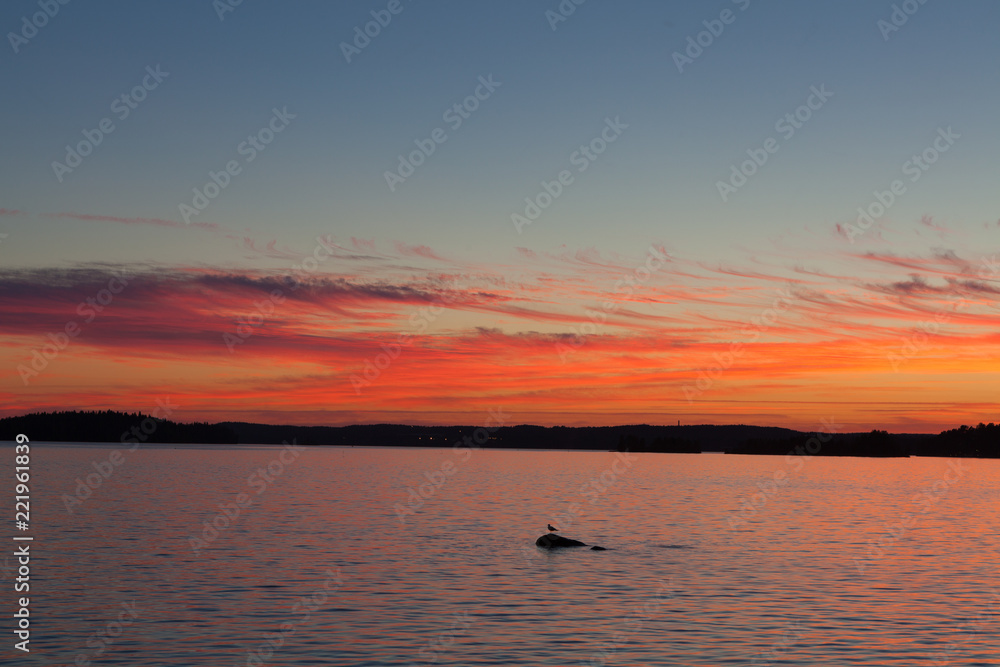 Calm sunset and clouds over lake in finland