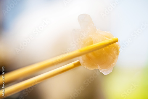 Chinese food and appetizer,dim sum Ha gow on chopsticks,Steamed Chinese gourmet cuisine.Chinese dim sum Hagao. photo