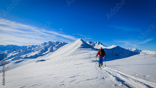 Ski with amazing view of swiss famous mountains in beautiful winter snow Mt Fort. The skituring, backcountry skiing in fresh powder snow. photo