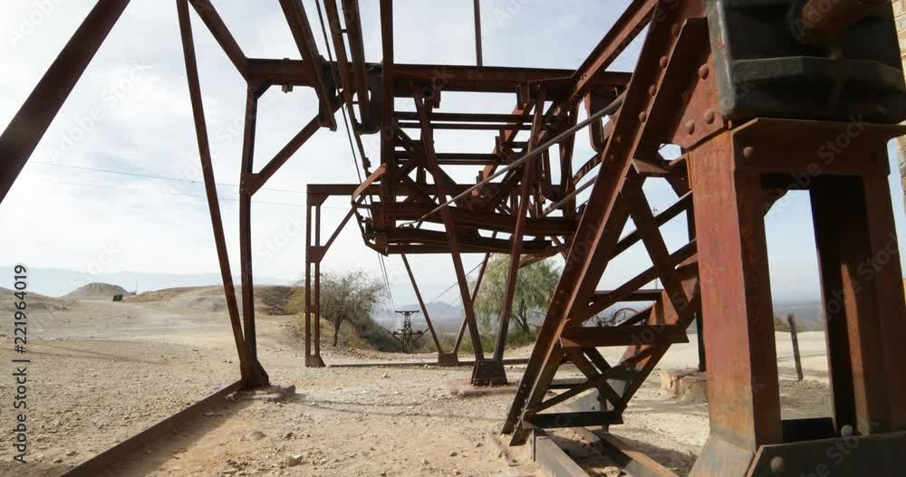 Second station of old Cable Car Chilecito-La Mejicana mine. Camera moves sideways showing rusty iron structure, cable and towers of the system, background of landscape with towers. National heritage Second station of old Cable Car Chilecito-La Mejicana mine. Camera moves sideways showing rusty iron structure, cable and towers of the system, background of landscape with towers. National heritage