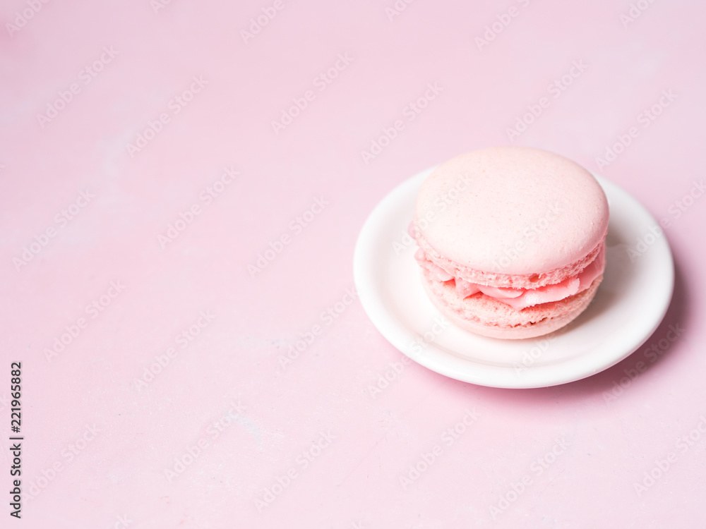 Fototapeta premium Pink colorful cake macaroon on pastel background, colorful almond cookies