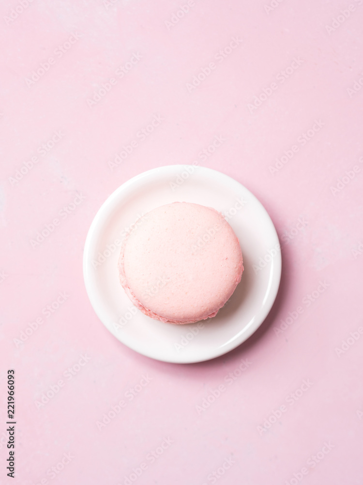 top view of Pink colorful almond cookie cake on saucer on pastel background top view of Pink colorful almond cookie cake on saucer on pastel background