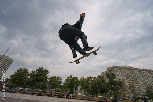 A skateboarder performs a stunt near the Lenin monument on a Kaluzhskaya square in Moscow photo