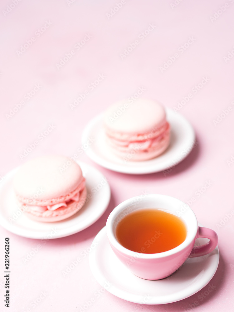 Still life with french delicious dessert macaroons and cup of coffee on pink background with copy space Still life with french delicious dessert macaroons and cup of coffee on pink background with copy space