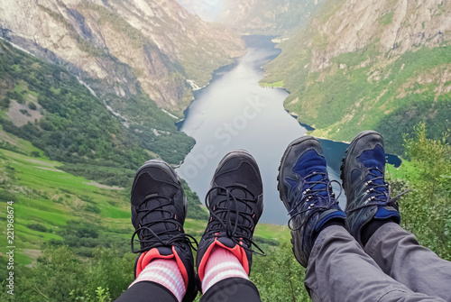 Woman's and man's feets over the fjord in norway.