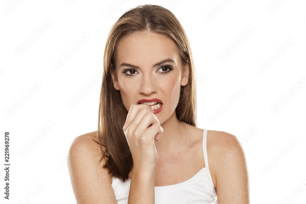 Nervous beautiful pensive girl on white background Nervous beautiful pensive girl on white background