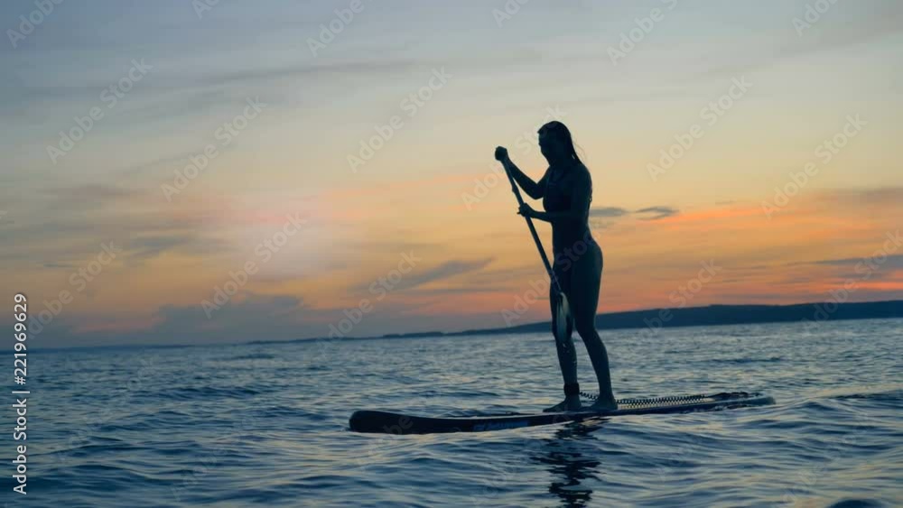 Athletic lady in the sunset. Summer holiday travel concept. Athletic lady in the sunset. Summer holiday travel concept.