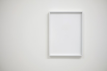 Empty white frame on white wall for interior decoration. Minimal concept