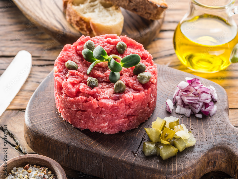 Steak tartare served with capers, pickled cucumbers and chopped onion.