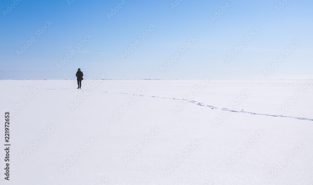 Lonely teenage girl walks in winter