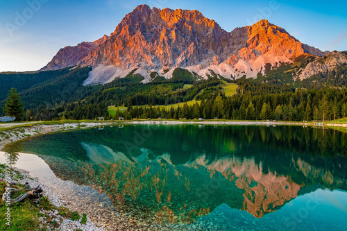 Принти на полотні A beautiful view on the Ehrwalder Almsee and the Zugspitze on a sunny summer day