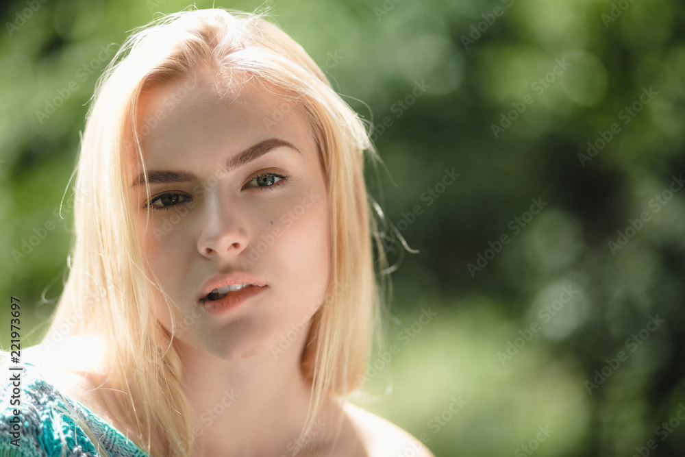 Close up portrait of lady biting her bottom lip. Attractive good looking woman with light hair covered in sunlight bitting her lip. Close up portrait of lady biting her bottom lip. Attractive good looking woman with light hair covered in sunlight bitting her lip.