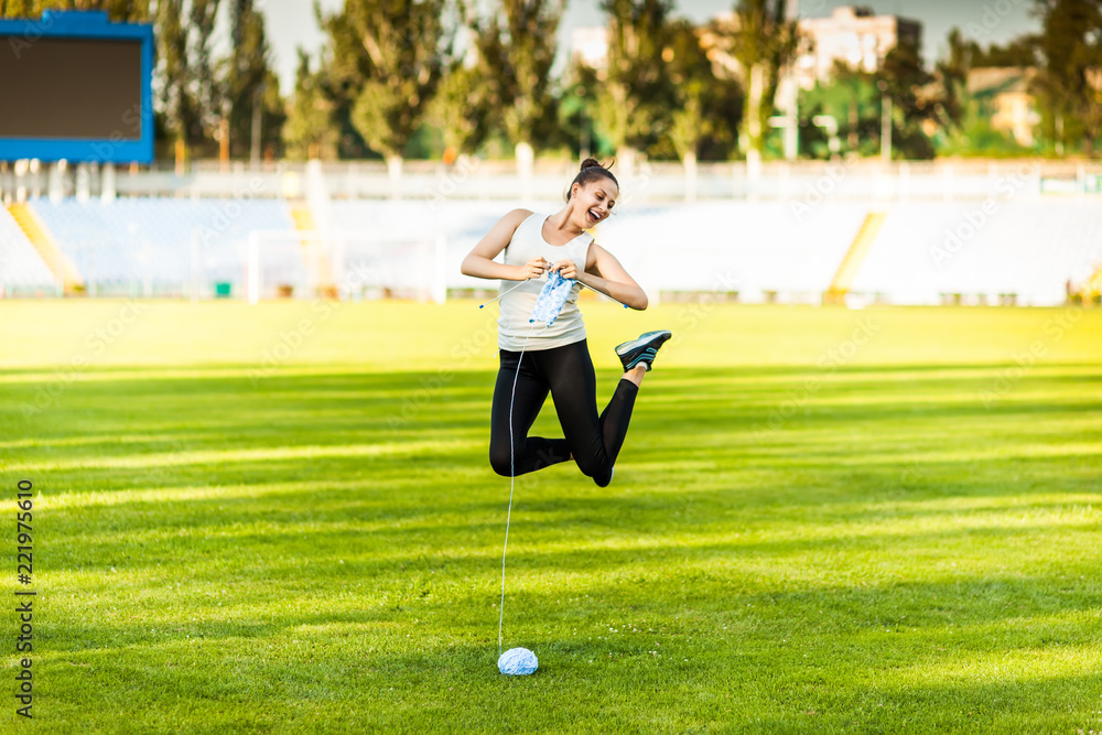 Woman athlete knitting a sweater on a football field Woman athlete knitting a sweater on a football field