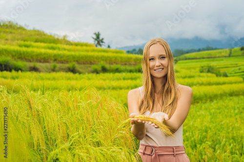 Young woman traveler on Beautiful Jatiluwih Rice Terraces against the background of famous volcanoes in Bali, Indonesia photo