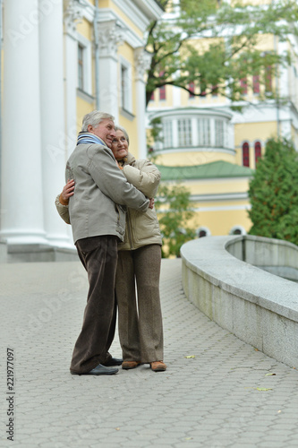 beautiful caucasian senior couple walking in city