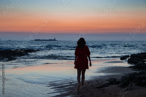 Silhouette of a teen girl at the beach