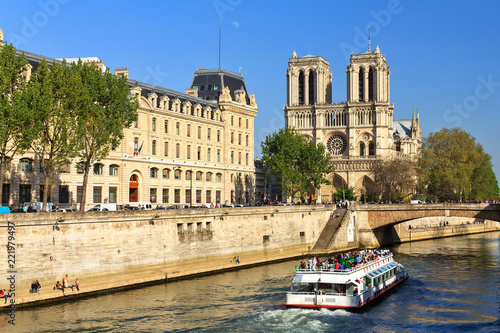 Beautiful view of the river Seine with a canal-boat and the Notre-Dame Cathedral in Paris 