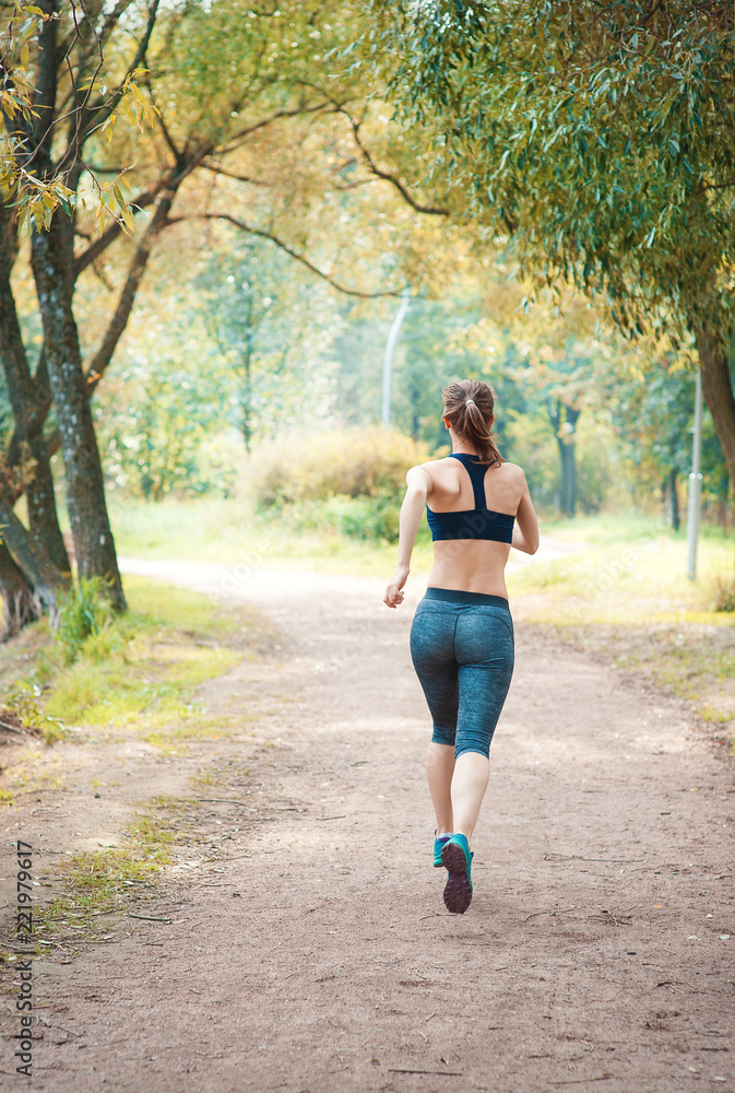 Active beautiful woman running in the park. Healthy lifestyle Active beautiful woman running in the park. Healthy lifestyle