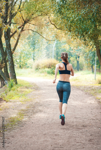 Active beautiful woman running in the park. Healthy lifestyle © darkbird