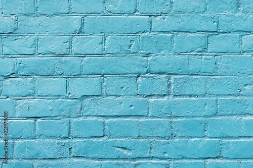 Painted brick surface close-up with celestial color of paint. Colorful grunge texture of wall. Abstract modern background, copy space